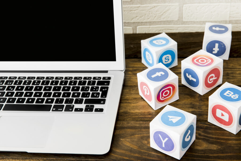 laptop near boxes social application icons table