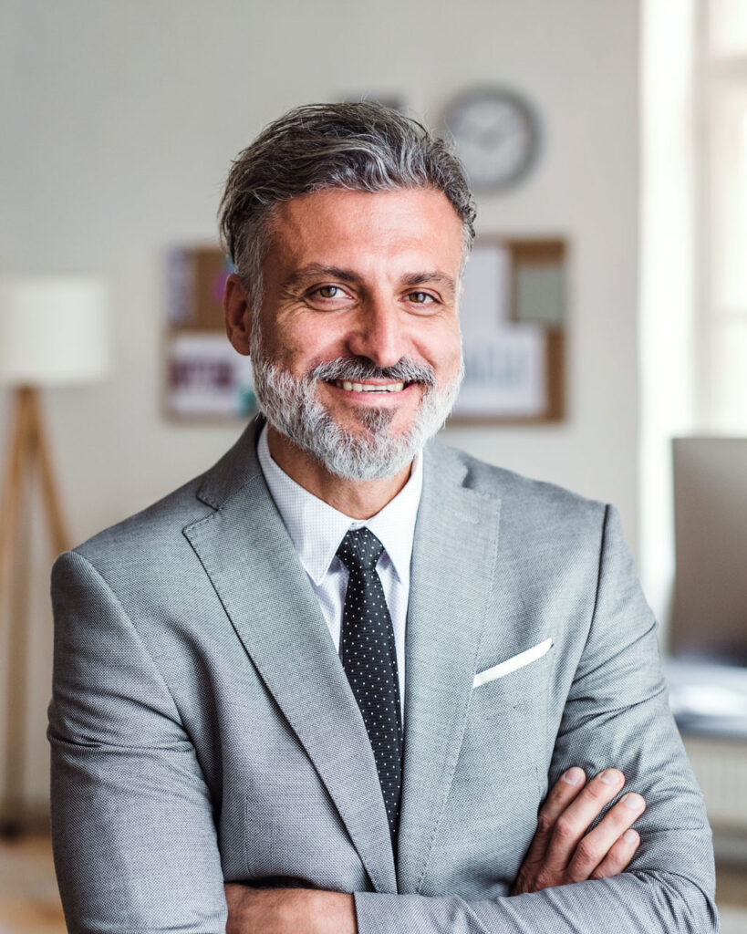 mature businessman standing in an office arms cros 3a5wz92.jpg